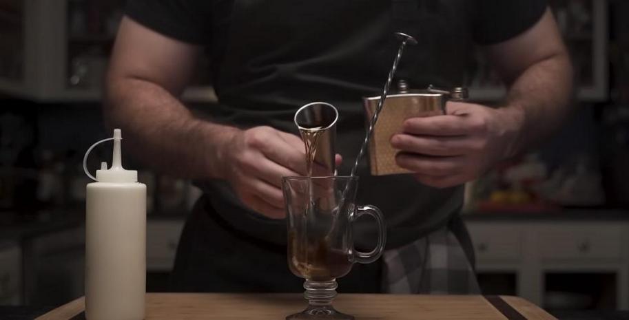 Whiskey poured into a coffee glass
