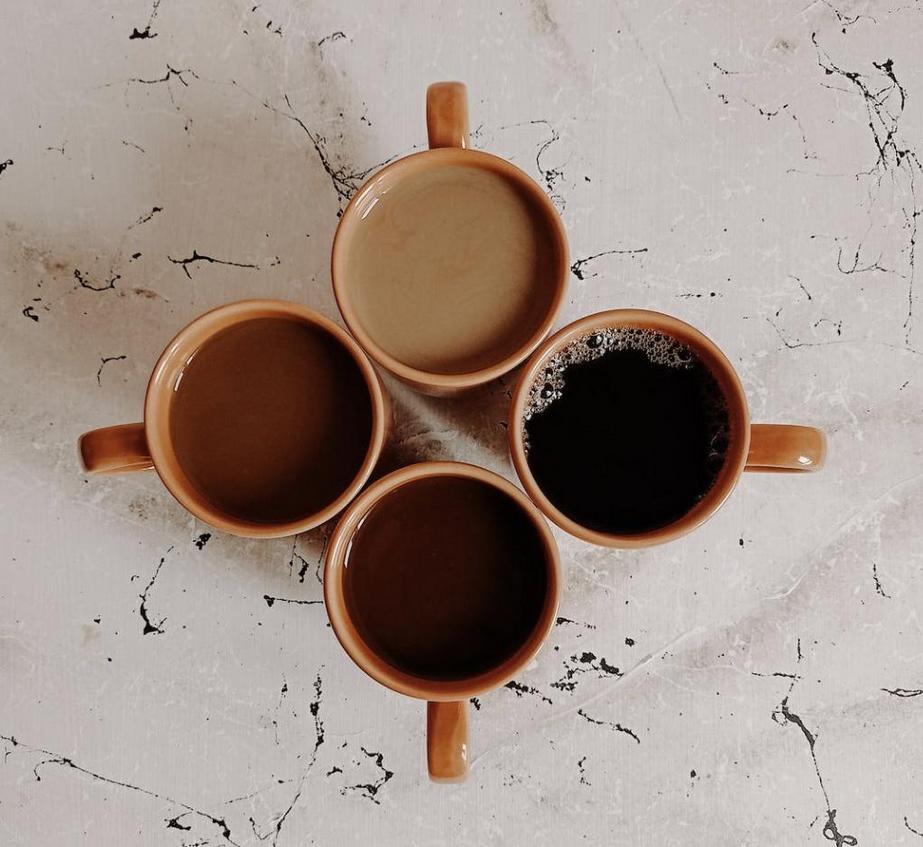 Top-down view of four cups of coffee with d