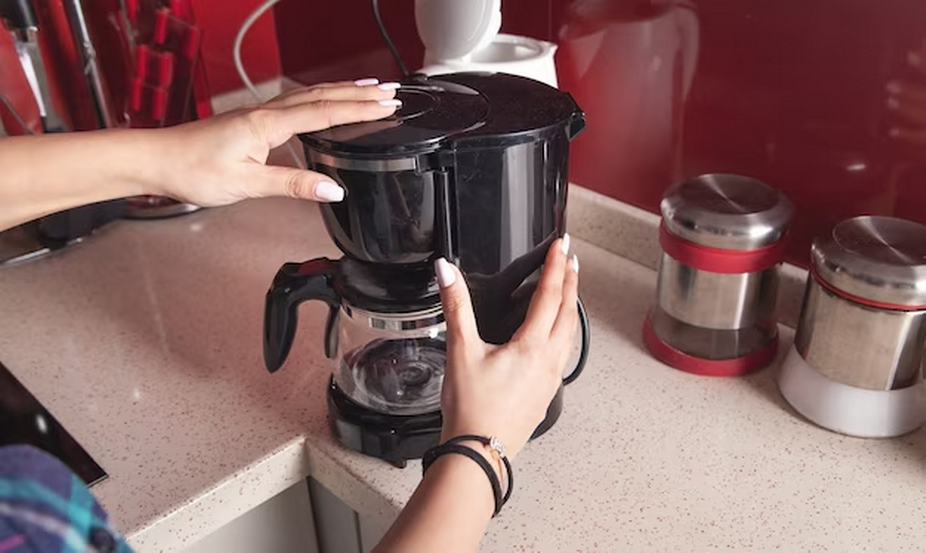 Hand holding a coffee pot